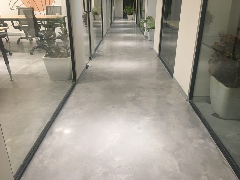 Glossy polished concrete floor reflecting light in a modern interior