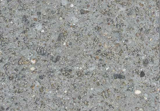 Textured concrete surface after scabbling process, revealing unevenness and exposed aggregate for better bonding.