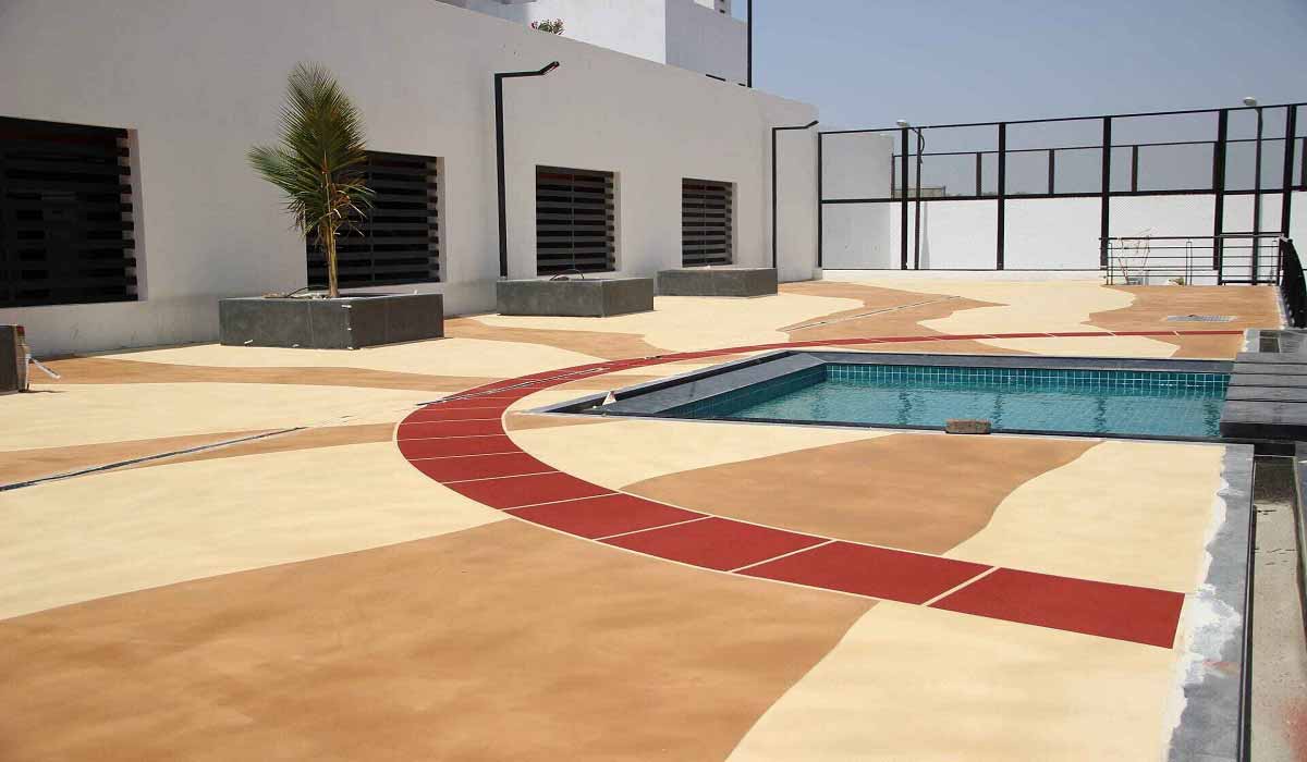 Industrial spray texture flooring system applied in a Pune, India facility.